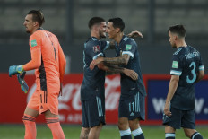 (Left) Argentina's goalkeeper Franco Armani, Rodrigo De Paul, Angel Di Maria and Nicolas Tagliafico celebrate after defeating Peru 2-0 in a closed-door 2022 FIFA World Cup South American qualifier football match at the National Stadium in Lima on November 17, 2020. 