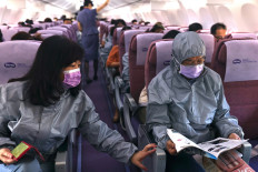 Z.C. Chen, chairman of BenQ, reads the duty-free magazine while wearing a protective outfit on a flight, amid the spread of the coronavirus disease (COVID-19), in Taipei, Taiwan, on November 19, 2020. 