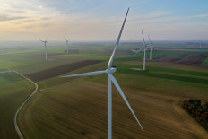 An aerial view shows power-generating windmill turbines in a wind farm in Graincourt-les-havrincourt, France, on November 7, 2020. 