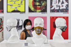 A visitor looks at posters and face masks displayed at an exhibition at Summarecon Mall Serpong in Tangerang, Banten. Coinciding with National Heroes Day on Nov. 10, the exhibition aims to spread the message that anyone can be a hero by wearing a mask and adhering to health protocols. JP/Seto Wardhana