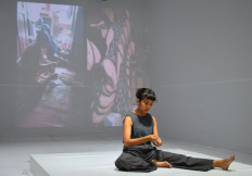 In a loop: Performer Arsita Iswardhani shows repetitive movements in 'How the Ghost Worker is Dancing in Your Shoes' in her response to work conditions of laborers in the fashion industry.