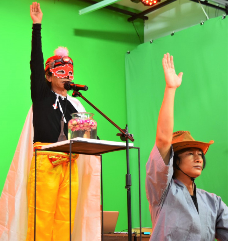 Show us the way: A false prophet, played by Gunawan Maryanto (left), with the help of Andreas Ari Dwiyanto as a disciple, delivers a sermon in an interactive show titled 'The Messiah for Dummies'.