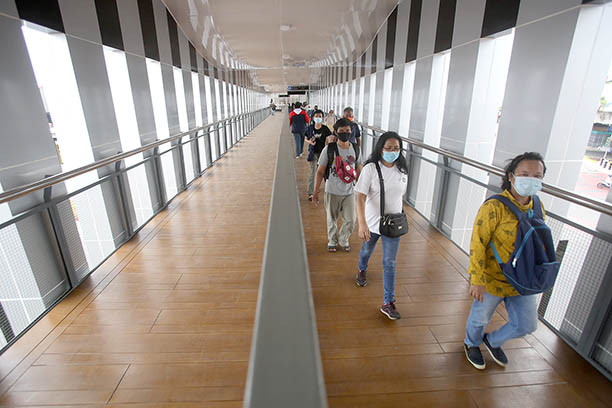 People walk along a pedestrian bridge in Senen, Central Jakarta, in November 2020.