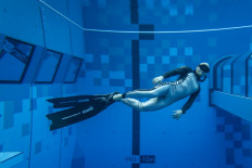 A diver is seen in the deepest pool in the world with 45.5-meter located in Mszczonow about 50 km from Warsaw, November 21, 2020. 