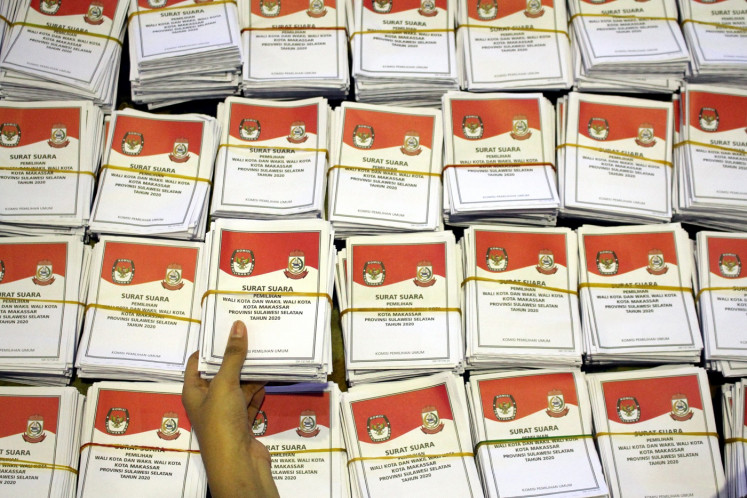 A worker arranges ballot papers for the regional elections on Nov. 24, 2020 at the Celebes Convention Center in South Sulawesi’s provincial capital Makassar.