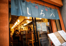 Sixty-year-old Yashiro Haga cooks ramen noodles before customers inside his noodle shop 'Shirohachi', amid the coronavirus disease (COVID-19) outbreak, in Tokyo, Japan, on November 20, 2020. 