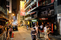 In this picture taken on May 14, 2020, people visit bars in Lan Kwai Fong, a popular drinking area, in Hong Kong.
