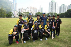 This picture taken on November 8, 2020 shows the SCC Divas cricket team, made up of domestic helpers from the Philippines, posing for a team photo ahead of their game against the Hong Kong Cricket Club Cavaliers in Hong Kong.