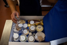 James Knappett, founder and head chef of 'Home', the first at-home fine dining experience, packs food into a box destined for customers in London, Britain, on November 18, 2020.