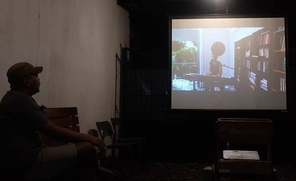 Growing community: A resident watches the opening of the 2020 Documentary Film Festival. Yogyakarta-based singer Leilani Hermiasih, known as Frau, performed and shared her reflections on the pandemic situation in a continuous shot, documentary style video.