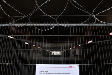 This photo taken on November 25, 2020 shows a sign reading 'Tegel Campus - access only with valid permanent of visitor ID' on a closed entrance to former Tegel airport in Berlin. 