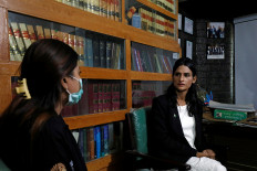 Nisha Rao, 28, a transgender woman who became country's first practicing lawyer, listens to one of her clients at office in Karachi, Pakistan, on November 23, 2020. 