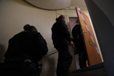 Police technicians enter an apartment in Haninge, south of Stockholm, on Tuesday, one day after a man in his 40s who was kept locked by his mother was found there. A mother in Sweden has been arrested on suspicion of locking her son inside their apartment for 28 years, leaving him undernourished and with almost no teeth, police and media reports said.
