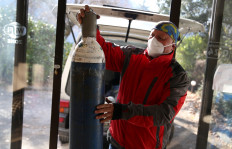 Miralem Sabic carries oxygen bottles from his private van to an improvised coronavirus disease (COVID-19) hospital in Konjic, Bosnia and Herzegovina, on November 27, 2020. 