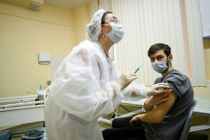 A nurse wearing a face mask proceeds to a vaccination against the coronavirus disease (COVID-19) by Sputnik V (Gam-COVID-Vac) vaccine at a clinic in Moscow on December 5, 2020, amid the ongoing coronavirus disease pandemic. - Russian President has told authorities to begin 