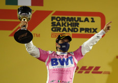 Racing Point's Sergio Perez celebrates on the podium with the trophy after winning the race at the Sakhir Bahrain International circuit on Sunday.