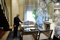 A cleaning staff member turns on a disinfection lamp inside a room at the Hotel Claris that is reinventing itself amid the coronavirus pandemic in Barcelona on October 22, 2020.  