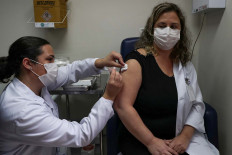 A nurse administers CoronaVac, a Sinovac's potential vaccine against the coronavirus disease (COVID-19), to a volunteer and nurse Sarah Rangon at Emilio Ribas Institute in Sao Paulo, Brazil July 30, 2020. Picture taken July 30, 2020. 