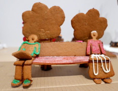 Two gingerbread figures sitting apart on a bench to illustrate social distancing are seen during the annual gingerbread baking competition at Arkdes Museum of Architecture and Design in Stockholm, Sweden, on December 7, 2020. 
