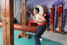 Wang Liutai demonstrates 'Iron Crotch Kungfu' at his martial arts academy in Juntun village of Luoyang, Henan province, China, on December 5, 2020. 