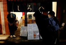 Yashiro Haga bow goodbye to his final customers on the day he closes his 'Shirohachi' ramen shop, following the coronavirus disease (COVID-19) outbreak, in Tokyo, Japan, on December 10, 2020. 
