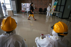 A COVID-19 patient takes part in voting day during the 2020 South Tangerang regional elections in Rumah Lawan COVID, an isolation center in South Tangerang on Dec. 9, 2020.