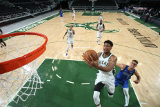 December 12: Giannis Antetokounmpo (34) of the Milwaukee Bucks shoots the ball against the Dallas Mavericks during a preseason game on Saturday at the Fiserv Forum Center in Milwaukee, Wisconsin. 