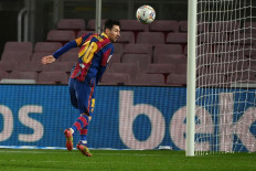 Barcelona's Argentinian forward Lionel Messi jumps for the ball during the Spanish league soccer match between FC Barcelona and Levante UD at the Camp Nou stadium in Barcelona on Sunday,