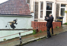 Banksy mural of sneezing woman appears on England's steepest street