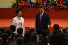 Hong Kong's new Chief Executive Carrie Lam (left) leaves the stage with China's President Xi Jinping (right) after being sworn in as the territory's new leader during a ceremony at the Hong Kong Convention and Exhibition Centre in Hong Kong on July 1, 2017. Lam became Hong Kong's new leader on July 1, which marks the culmination of the lifelong civil servant's career as she inherits a divided city fearful of China's encroaching influence.