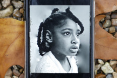 A photograph taken in London on November 30, 2020 shows a mobile phone displaying a photograph of Ella Adoo-Kissi-Debrah who died in February 2013 from a severe asthma attack. 