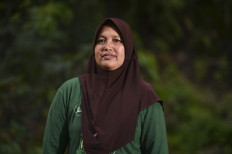 This picture taken on November 25, 2020 shows Indonesian housewife and forest ranger Sumini, 45, leading a group of women volunteers fighting a David-versus-Goliath battle to stop devastating deforestation and poaching of critically endangered wildlife in the forests where they live, including Sumatran tigers and pangolins in Bener Meriah, Aceh province.