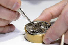 In this file photo taken on January 18, 2016 an employee of Swiss watchmaker Audemars Piguet assembles a watch, during the opening day of the Salon International de la Haute Horlogerie (SIHH), a professional fair in fine watchmaking, in Geneva.  