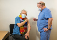 Actor Ian McKellen looks on as he receives the Pfizer-BioNTech COVID-19 vaccine from GP Dr Phil Bennett-Richards at the Arts Research Centre, Queen Mary University Hospital, in London, Britain, on December 16, 2020. 