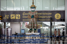 A traditional Thai statue wears a face mask as a campaign for travellers to prevent the spread of Covid-19 coronavirus at the departure terminal of Suvarnabhumi International Airport in Bangkok on December 18, 2020. 