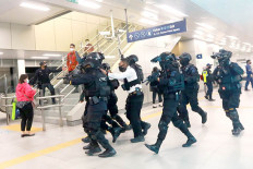 This is a drill: Personnel from the National Police’s antiterrorism squad Densus 88 take action against a simulated terrorist in an exercise in Lebak Bulus MRT station in South Jakarta on Dec. 16, 2020. 