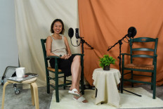 This picture taken on October 7, 2020 shows Nicole Lim smiling as she poses during the recording of an episode of her podcast 'Something Private' in Singapore. 