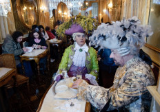 Costumed revelers have snack in the famous Caffe Florian on San Marco square in Venice on February 14, 2009 at the beginning of the annual Venice Carnival Sensation 2009. 
