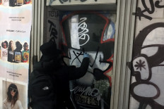Graffiti artist Saynosleep paints a door in New York City on December 15, 2020. 