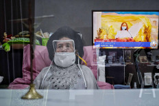 Thutty Soekotjo, 92, watches an online Holy Mass in South Tangerang, Banten, on Dec. 24. Most Christians attended online masses as churches implemented strict health protocol, including restricting the age and limiting numbers of congregants, to curb COVID-19 transmission during Christmas. JP/Seto Wardhana