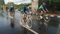 Slick ride: Cyclist ride along a wet road during Bali Beach Bike, a cycling festival organized by budget airline Citilink and online travel agency Tiket.com to help revive tourism on the island resort of Bali.