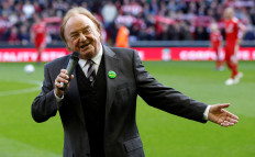 Liverpool supporter and singer Gerry Marsden sings You'll Never Walk Alone before their English Premier League soccer match against Blackburn Rovers at Anfield in Liverpool, northern England, Oct.24, 2010. 