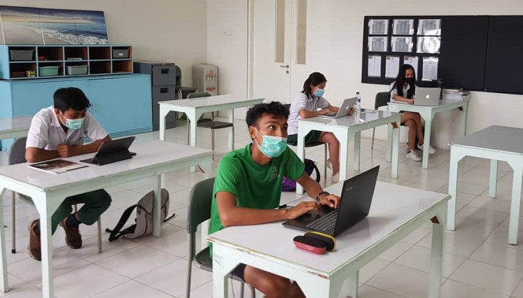 Back in school: Secondary students socially distance for face-to-face learning during a simulated lesson at Sekolah Nusa Alam in Mataram in December.