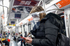 A woman wearing a protective face shield travels on a subway as Italians prepare for tighter restrictions as part of efforts to curb the spread of COVID-19, in Rome, on Jan. 8. Italy was one of the first countries in the world that were hit hard by the pandemic but has in recent months recorded a sharp fall in cases.