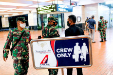 Indonesian soldiers are seen at Soekarno-Hatta International Airport in Tangerang, Banten, after Sriwijaya Air flight SJ182 with more than 50 people on board lost contact after taking off on Saturday afternoon, according to local media.