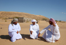 Former inhabitants of Wadi al-Murr, gather near abandoned houses in the Omani village, about 400 kms (250 miles) southwest of the capital Muscat, on December 31, 2020. Encroaching desert sands have left little evidence that Wadi al-Murr ever existed, but former inhabitants, while resigned to its destruction, are trying to preserve its memory.