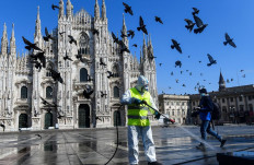 Fly zone: A government worker sprays disinfectant outside Piazza Duomo in Milan during Italy’s coronavirus lockdown on March 31, 2020. The pandemic hit Italy’s economy hard but allowed e-commerce to grow in 2020