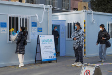 People line up to get their nucleic acid test in the courtyard of a hospital following the outbreak of the coronavirus disease (COVID-19) in Beijing, China, January 13, 2021. 
