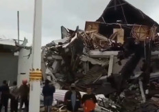 Survivors gathered around the West Sulawesi governor's office in Mamuju, which was destroyed by an earthquake on Jan. 15, 2020.