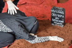 Aldha Refa, the wife of Okky Bisma, a flight attendant and one of the 62 people aboard Sriwijaya Air flight SJ182 which crashed shortly after takeoff on January 9, grieves at his funeral in Jakarta on January 14, 2021. 